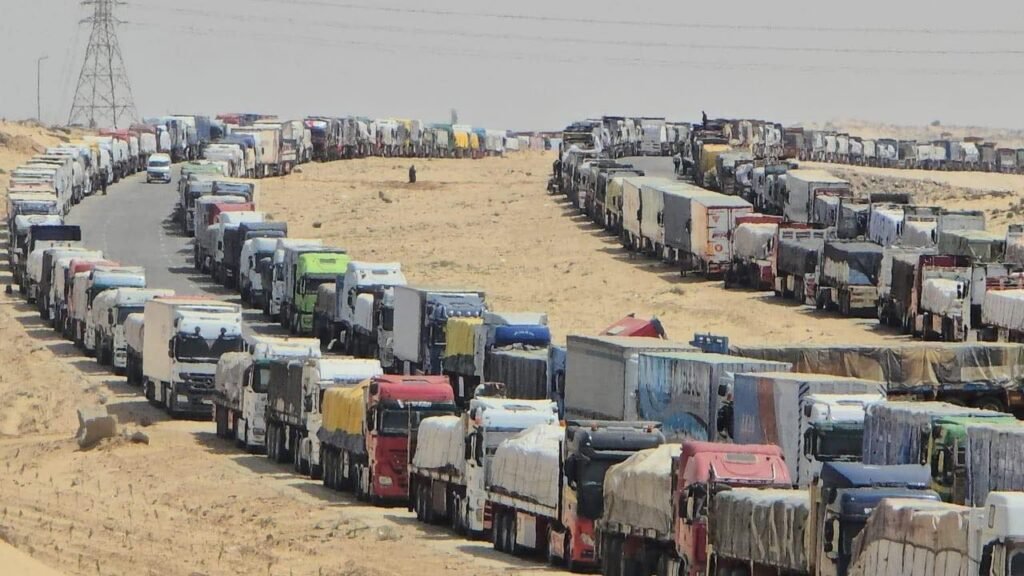 Hundreds of tons of aid, loaded in countless trucks, stand stranded at the Rafah border—so close, yet barred f